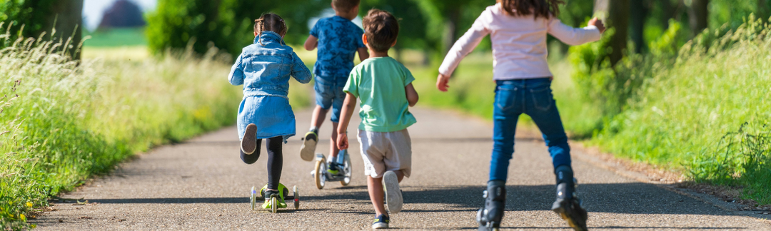 Children running and roller blading outdoors
